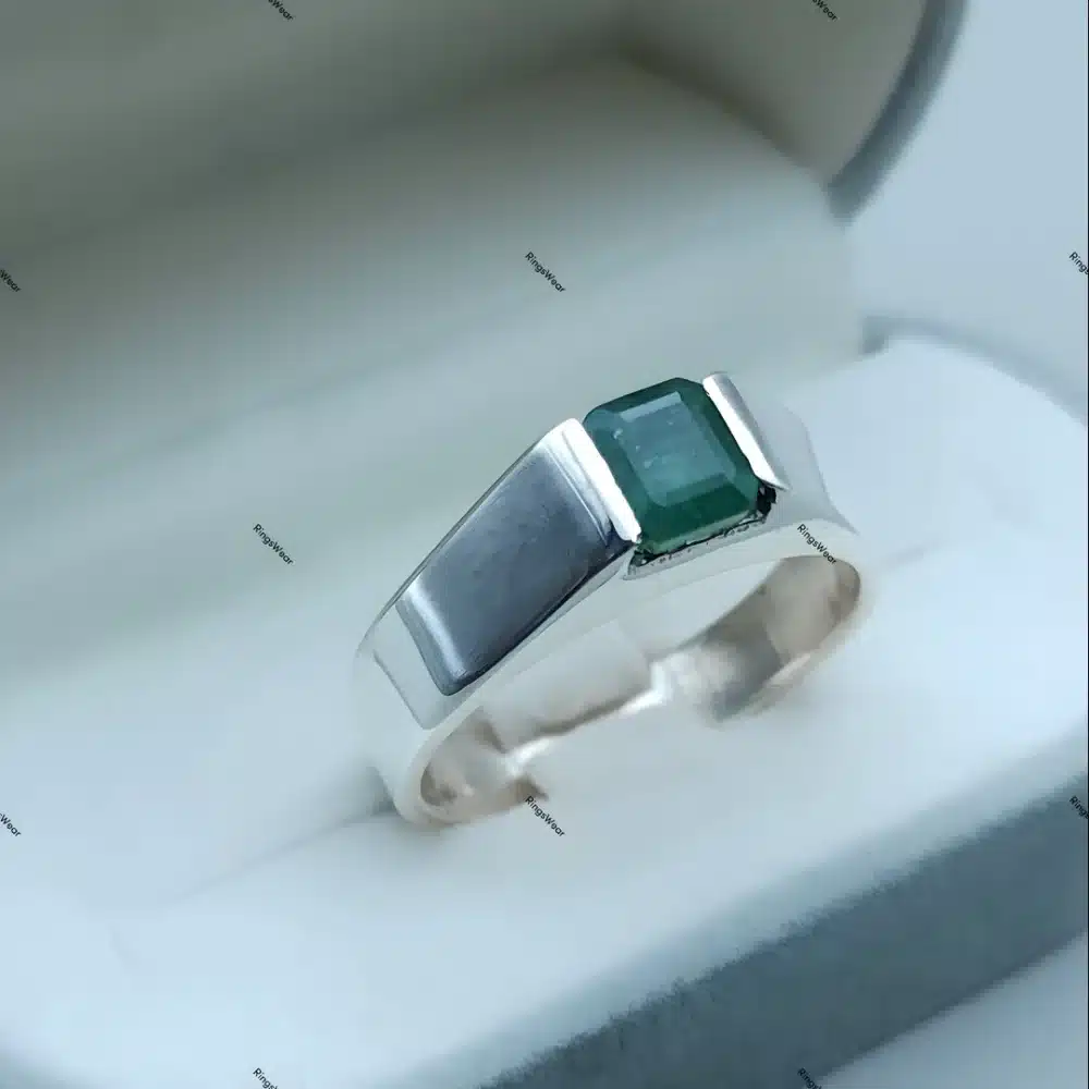 Silver ring with green gemstone centerpiece